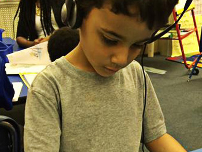 A young child wearing headphones